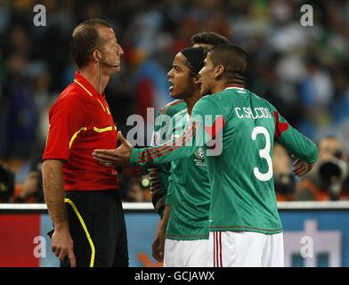 (left-right) Mexico's Dos Santos Giovani and Carlos Salcido appeal to the linesman after they concede the opening goal of the game Stock Photo
