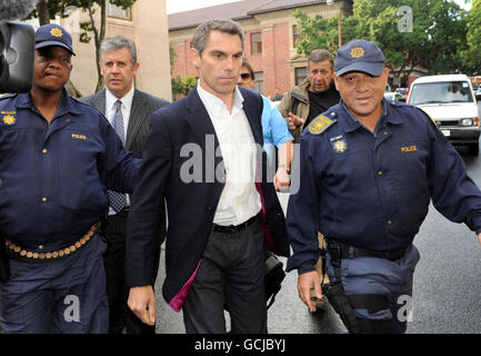Sunday Mirror journalist Simon Wright (centre) leaves Cape Town Magistrates after his case of charges of defeating the ends of justice and flouting the immigration act was adjourned until July 7, Cape Town, South Africa. Stock Photo