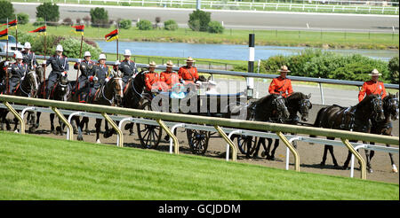 Britain's Queen Elizabeth II and the Duke of Edinburgh ride in an open topped horse drawn carriage at the Woodbine Racetrack to see the Queen's Plate Stakes - Canada's oldest thoroughbred race, in Toronto, Canada. Stock Photo