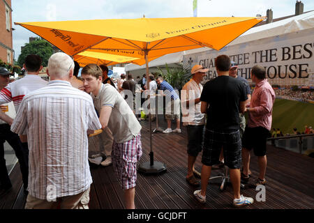 Guests enjoy one of the outside bars at the Brit Oval Stock Photo