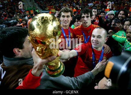 Soccer - 2010 FIFA World Cup South Africa - Final - Netherlands v Spain - Soccer City Stadium. Spain's Andres Iniesta celebrates with the World Cup trophy after winning against Netherlands Stock Photo