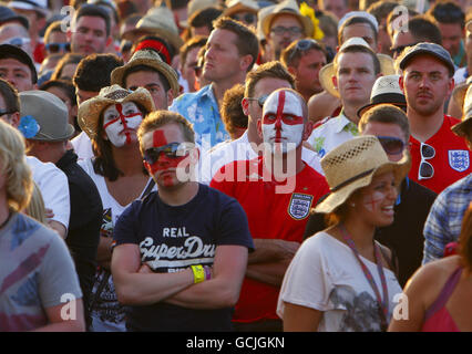 Football fans react to England playing the USA at the World Cup on a big screen at the Isle of Wight Music Festival. Stock Photo