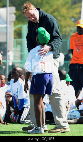 Prince William plays football with local children during a visit to the Coaching for Conservation project in Maun, Botswana. Stock Photo