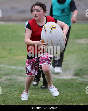 Children take part during Street Rugby on The Green in Lochgoilhead, Scotland. Stock Photo