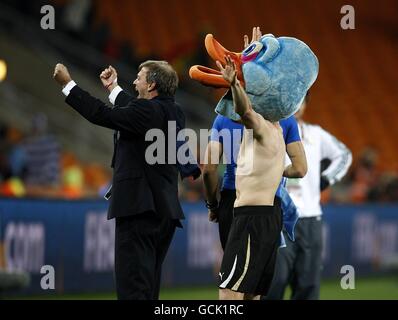 Uruguay's Diego Perez (with mascot head) celebrates after the game Stock Photo