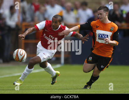 Soccer - Pre Season Friendly - Barnet v Arsenal - Underhill Stadium. Arsenal's Theo Walcott holds off challenge from Barnet's Mark Byrne (right) during the preseason friendly match at Underhill, London. Stock Photo