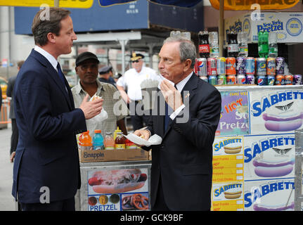 Prime Minister David Cameron enjoys a hotdog with New York City Mayor Michael Bloomberg as he arrived at Penn Station from Washington DC today, as part of his two day visit to the US. Stock Photo
