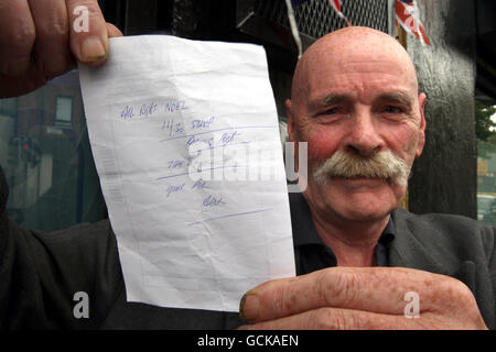 Noel Cairns holds a shopping list given to him by former snooker champion Alex Higgins, near Ulidia House in south Belfast where Higgin's body was discovered after concerned friends broke into his Belfast flat having failed to contact him by phone. It is not known how long he had been dead inside the apartment. Stock Photo