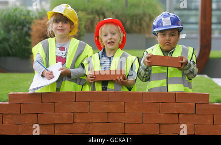 (from left) Patients at London's Great Ormond Street Hospital Alice Hipkiss, six, Joe Craddock, four and Mark Matthews, six, build a wall to celebrate Morgan Stanley meeting their 10 million target towards a new clinical building at the children's hospital and raising an additional 400,000 - making 10.4 million in total. Stock Photo