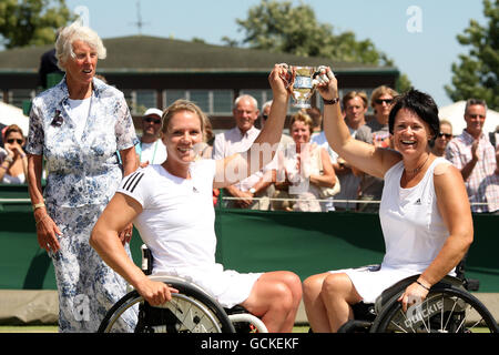 1969 Wimbledon Ladies' Singles champion Ann Jones (l) looks on as Netherland's Esther Vergeer (left) and Sharon Walraven celebrate with the trophy after winning the Final of the Wheelchair Ladies' Doubles against Australia's Daniela Di Toro and Great Britain's Lucy Shuker Stock Photo