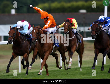 Triple Aspect (right in Blue) ridden by Liam Jones on their way to victory in The Coral Charge during Coral-Eclipse Day at Sandown Park Racecourse, Sandown. Stock Photo