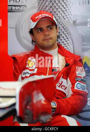 Ferrari's Felipe Massa in the garage before the first practice session during a practice day ahead of the Santander British Grand Prix at Silverstone Circuit, Northampton. Stock Photo