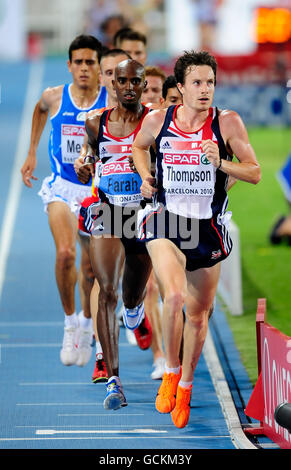 Athletics - IAAF European Championships 2010 - Day One - Olympic Stadium. Great Britain's Mo Farah follows his team mate Chris Thompson on his way to victory in the 10,000 metres final Stock Photo