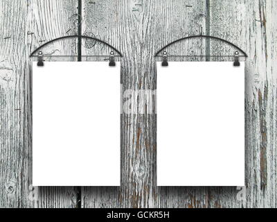 Close-up of two square blank frames hanged by clothes hanger against gray weathered wooden boards background Stock Photo