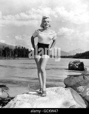The beauty of Marilyn Monroe vies with the natural beauty of Jasper National Park, Alberta, Canada, in this study of the star who is featuring in the new 20th Century Fox Film 'River of no Return'. Robert Mitchum and Rory Calhounr (not pictured) also star in this Technicolour Cinemascope production. Stock Photo