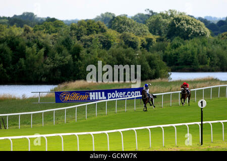 Horse Racing - Ripon Racecourse. Jockey David Allan on Mariachi Man leads from jockey Michael Stainton on Mayan Flight during the Mike Burton Memorial Maiden Auction Stakes Stock Photo