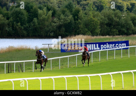 Horse Racing - Ripon Racecourse. Jockey David Allan on Mariachi Man leads from jockey Michael Stainton on Mayan Flight during the Mike Burton Memorial Maiden Auction Stakes Stock Photo