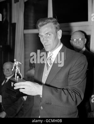 Proudly hugging his silver statuette trophy is Manchester City and England star Don Revie. He received the 'Footballer of the Year' award at the annual dinner for the members of the Football Writers' Association. Stock Photo