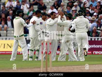 Pakistan's Saeed Ajmal (centre) is congratulated by teammates after catching England's Graeme Swann off his own bowling during the npower Second Test at Edgbaston, Birmingham. Stock Photo