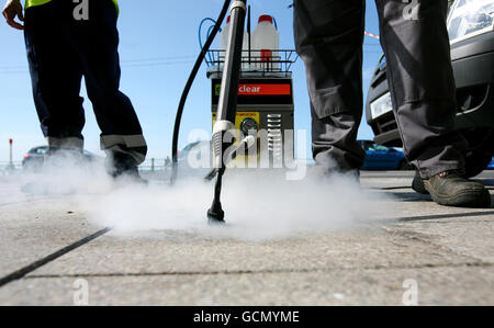 A Brighton & Hove council worker uses a new clean, capture and recycling machine in Brighton, East Sussex, which is designed to clear up 100,000 pieces of gum a day from the city's streets while only using 3 percent of the water used by other gum busting machines. Stock Photo