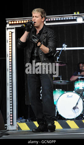 Kian Egan of Westlife performs on stage during Ladies Day at Newbury Races, Berkshire today. Stock Photo