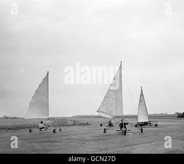 With the grace and beauty of their marine counterparts, and at speeds of up to 50 m.p.h. four land yachts race down the runway at Great Gransden. Stock Photo
