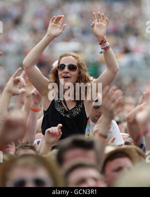 The crowd watching Professor Green performing on the 4 Music Stage, during the V Festival at Hylands Park in Chelmsford, Essex. Stock Photo