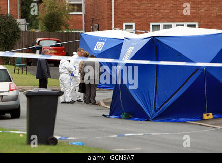 Police officers examine the scene of a murder after a man was stabbed to death. West Midlands Police said two other men also suffered stab wounds during the incident in Crosby Close, Whitmore Reans, Wolverhampton at about 10.45pm yesterday. Stock Photo