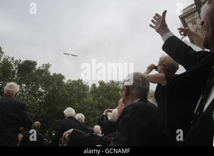 World War II veteran fighter pilots watch a flyby of a Hurricane and a Spitfire, by the Battle of Memorial Flight outside the Churchill War Rooms in central London where Robert Hardy read Winston Churchill's 'The Few' speech to commemorate the 70th anniversary of the Battle of Britain. Stock Photo