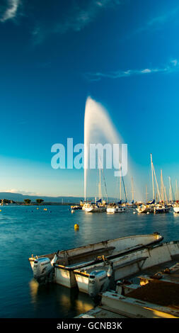 A view of Geneva's landmark as seen from Quai Gustave-ador during a blue sky day.  The Jet d'Eau is a large fountain in Geneva, Stock Photo