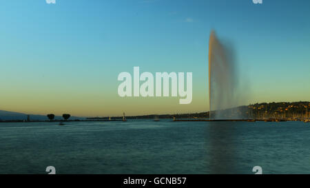 A view of Geneva's landmark as seen from Jardim Anlgais during a blue sky day.  The Jet d'Eau is a large fountain in Geneva, Swi Stock Photo