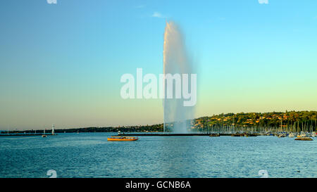 A view of Geneva's landmark as seen from Jardim Anlgais during a blue sky day.  The Jet d'Eau is a large fountain in Geneva, Swi Stock Photo