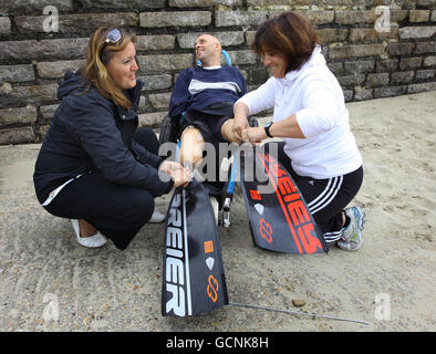 Frenchman Philippe Croizon is fitted with prosthetic legs with flippers attached by team members during a training session in Folkestone, Kent, before his attempt later this week to become the first limbless person to swim the Channel from Folkestone to France a distance of 21 miles. Stock Photo