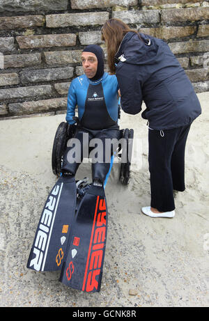 Frenchman Philippe Croizon is fitted with prosthetic legs with flippers attached by team members during a training session in Folkestone, Kent, before his attempt later this week to become the first limbless person to swim the Channel from Folkestone to France a distance of 21 miles. Stock Photo