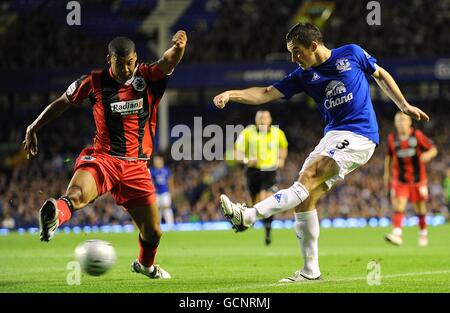 Everton's Leighton Baines (right) in action with Huddersfield Town's Lee Peltier Stock Photo