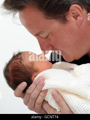 Previously unreleased photo of Prime Minister David Cameron holding his baby daughter, Florence Rose Endellion Cameron who was born on Tuesday August 24, during their summer holiday in Cornwall. Stock Photo