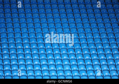 General view of rows of blue plastic seats in the stands at Brunton Park Stock Photo