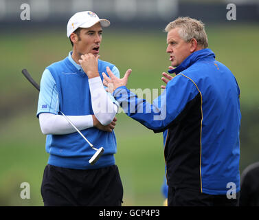 European Captain Colin Montgomerie (right) speaks with Europe's Ross Fisher during a practice round at Celtic Manor, Newport. Stock Photo