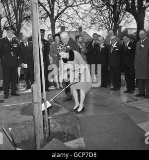 Queen Elizabeth II planting a mountain ash tree during a ceremony at the National Institute of Agricultural Botany in Cambridge, in connection with the 50th anniversary of its foundation. Stock Photo