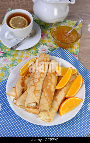 Pancakes stuffed with cottage cheese and oranges for breakfast Stock Photo