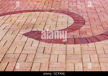 close up brick paved promenade background with red curved  patterns and textures Stock Photo