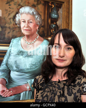 Award-winning painter Isobel Peachey, 31, stands next to her official portrait of Britain's Queen Elizabeth II , unveiled at the National Portrait Gallery in central London. Stock Photo