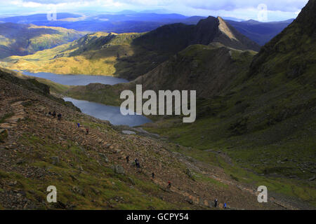 Walkers in Snowdon overlooking the Twin Lakes on the Pyg Track. Stock Photo