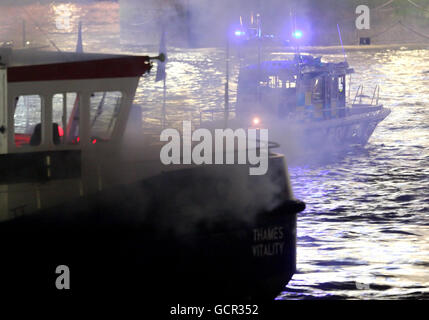 Police patrol boats are seen alongside a passenger boat on the river Thames, in central London, during an exercise to test the London Emergency Services Panel (LESLP) procedures in response to a major incident on the Thames. Stock Photo