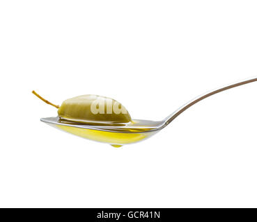 Green olive in full oil spoon on white background, isolated Stock Photo