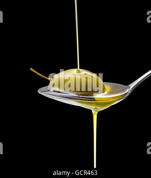 Green olive in full oil spoon on black background, isolated Stock Photo