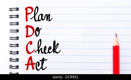 PDCA Plan Do Check Act written on notebook page with red pencil on the right Stock Photo
