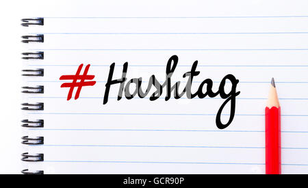 # Hashtag written on notebook page with red pencil on the right Stock Photo