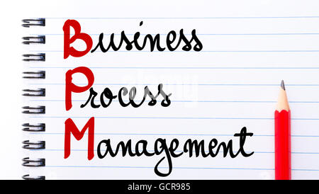 BPM Business Process Management written on notebook page with red pencil on the right Stock Photo
