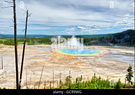 Grand Prismatic Spring and Excelsior Geyser flocked with tourists seen from a nearby hill in the south. Stock Photo